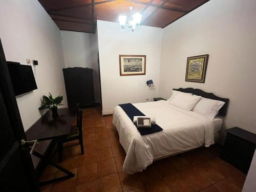 a bedroom with a bed with a tray on it at Hotel y Restaurante Posada Real in Quetzaltenango
