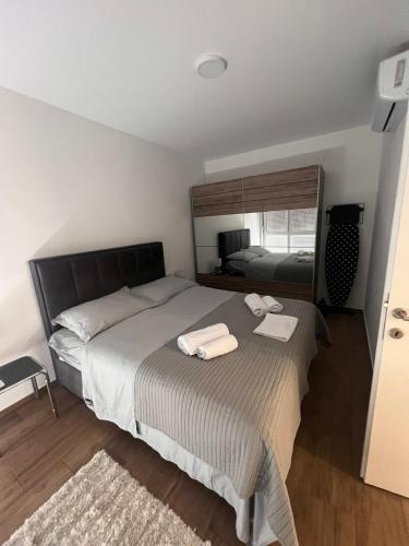 a bedroom with a bed with two towels on it at Apartman Karmen in Brodarica