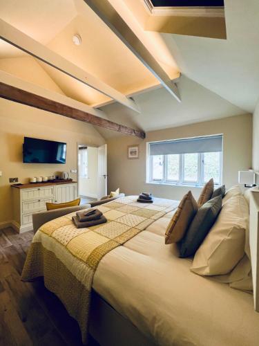 a bedroom with a large bed in a room at Dingle Marsh Barns in Dunwich