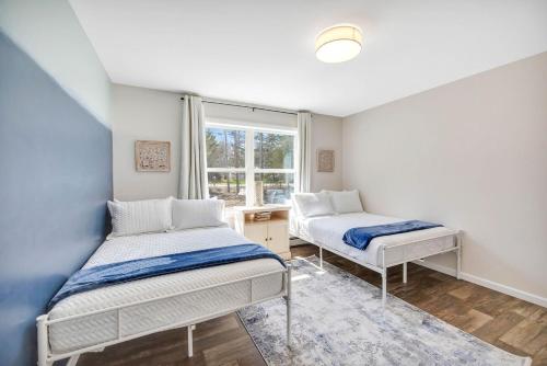 a bedroom with two beds and a window at Coastal Maine Escape in Ellsworth