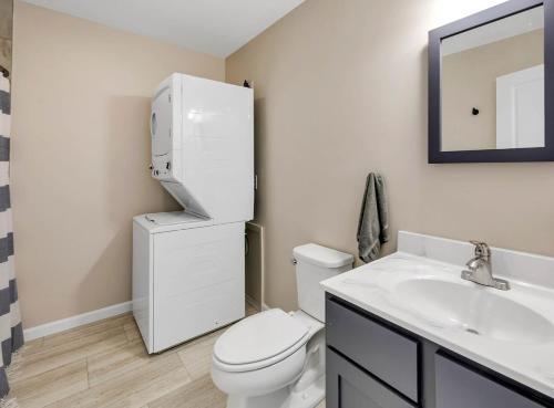 a bathroom with a white toilet and a sink at Coastal Maine Escape in Ellsworth