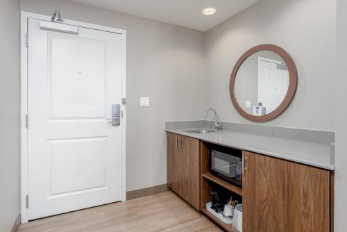 a bathroom with a sink and a mirror at Hampton Inn & Suites - Orange Beach in Orange Beach