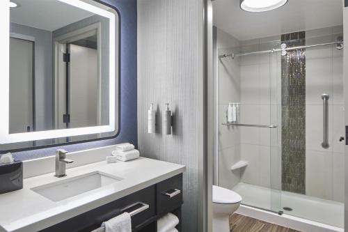 a bathroom with a sink and a toilet and a shower at Homewood Suites Savannah Historic District/Riverfront in Savannah