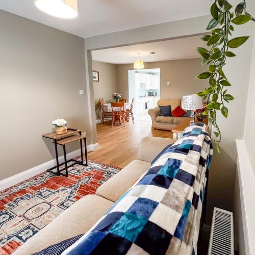 a living room with a couch and a table at killarney Townhouse with super location in Killarney