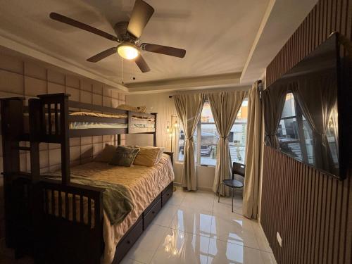 a bedroom with a bunk bed and a ceiling fan at Baja Ocean View 3 BR Panoramic Terrace & Private Jacuzzi 8pp in Rosarito