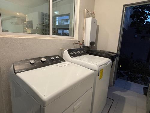 a washer and dryer in a room with a window at Baja Ocean View 3 BR Panoramic Terrace & Private Jacuzzi 8pp in Rosarito
