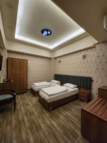 a bedroom with two beds and a skylight at Al-Mahasen Hotel in An Najaf