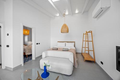 a bedroom with a bed and a ladder and a table at Vista Azul by Vintage Travel in Loulé