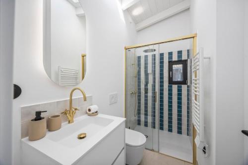 a white bathroom with a sink and a shower at Vista Azul by Vintage Travel in Loulé