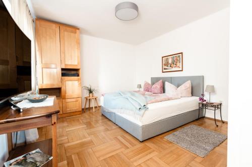 a bedroom with a bed with pink pillows at Pension Kohlweg - Free Parking, Garden and air conditioning in Graz