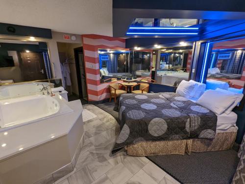 a bedroom with a bed and a bath tub at Hickory West Inn in Hickory Hills