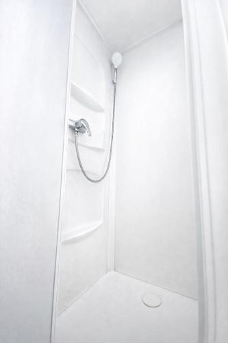 a shower in a bathroom with a glass door at Chez ValJean in Châlus