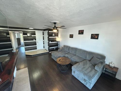 a living room with a couch and a ceiling fan at Private Oasis Condo with River views across from Laughlin in Bullhead City