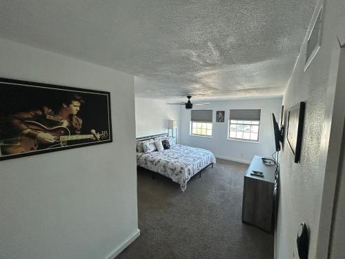 a bedroom with a bed and a painting on the wall at Private Oasis Condo with River views across from Laughlin in Bullhead City