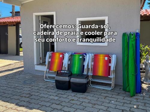a group of colorful drums sitting in front of a building at Moreno Guest House com Piscina, churrasqueira Praia de Itaguaré e Riviera in Bertioga