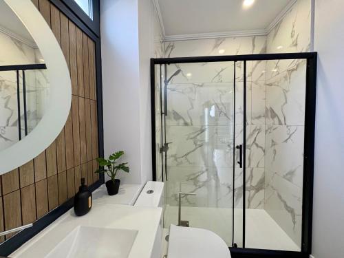 a bathroom with a shower and a sink at Maria s Guest House, By OP in Ponta Delgada