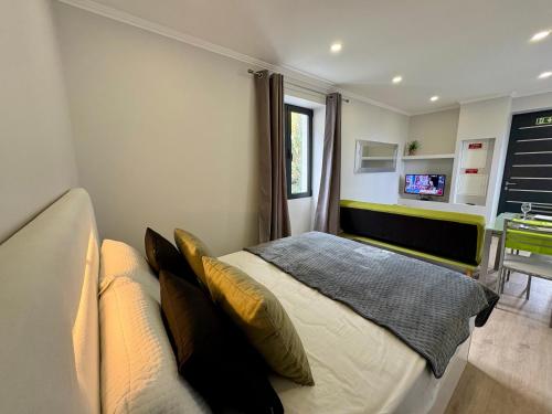a bedroom with a bed and a couch at Maria s Guest House, By OP in Ponta Delgada