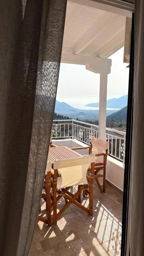 a patio with a table and chairs on a balcony at Casa Dimilia in Sívros