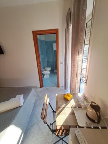 a room with a bed and a table and a toilet at sognandocasab&b tortora in Praia a Mare