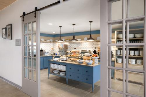a kitchen with a blue island with food on it at Country Inn & Suites by Radisson, Charlottesville-UVA, VA in Charlottesville