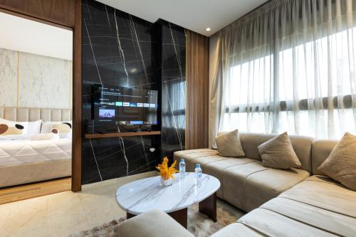a living room with a couch and a table at Elite Home in Maarif