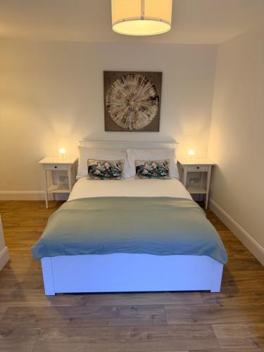 a bedroom with a large bed with two night stands at 2 Bed Apartment with Harbour Views Apt 2 in Cobh