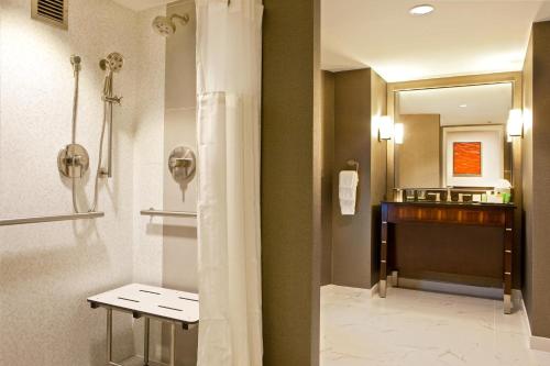 a bathroom with a shower curtain and a sink at Hilton Nashville Downtown in Nashville