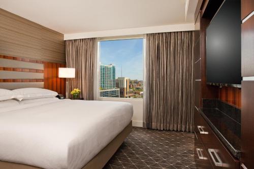 a hotel room with a bed and a large window at Hilton Nashville Downtown in Nashville