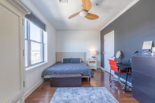 a bedroom with a bed and a ceiling fan at King Master and Plush Queen near NYC w kitchen, living room plus on-site gym in Jersey City