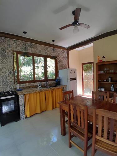 a kitchen with a wooden table and a kitchen with a counter at Casa da Ponte, Trindade in Trindade