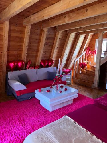 a living room with a couch and a table at Sea View Wooden Houses - Resort Sokoli in Lezhë