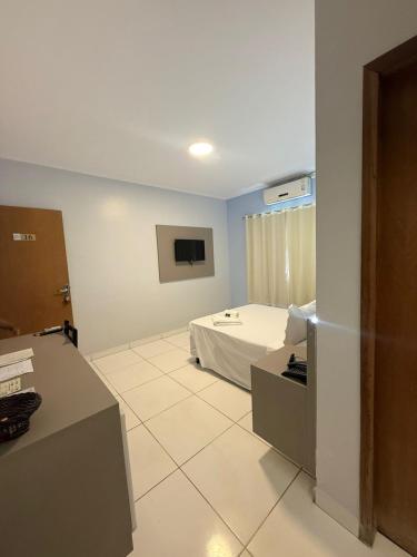 a room with a bed and a tv in it at PUMMA BUDGET HOTEL in Canaã dos Carajás