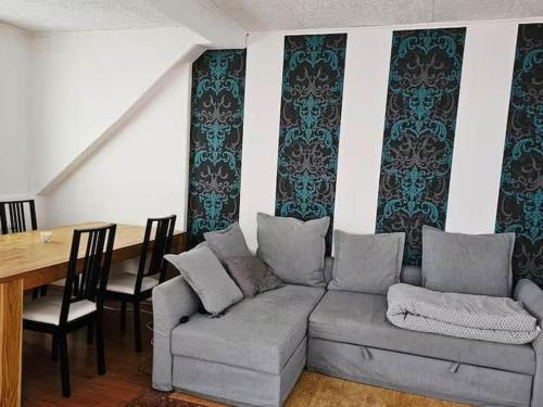 a living room with a couch and a dining room table at Dachgeschosswohnung in historischem Monument in Görlitz