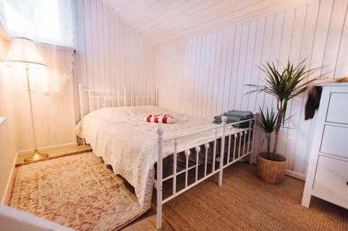 a bedroom with a white bed in a room at Hishka Ishka Love in Iška