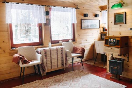 a room with chairs and a table and a stove at Hishka Ishka Love in Iška