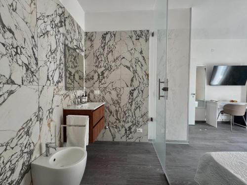 a bathroom with a toilet and a sink and a shower at Perla di Mare in Martinsicuro
