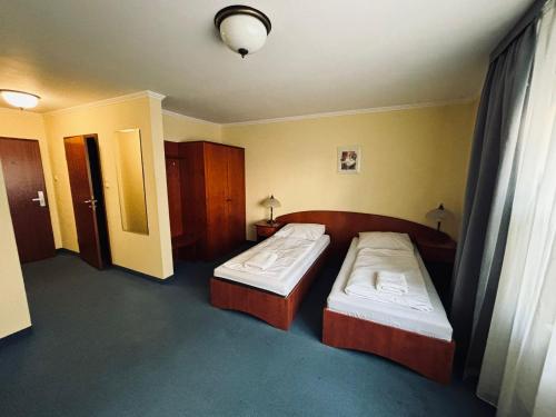 a hotel room with two beds and a window at Pokoje Stary Rynek in Elblag