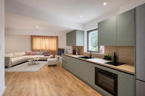 une cuisine et un salon avec un canapé dans l'établissement Dior Apartment, à Vlorë