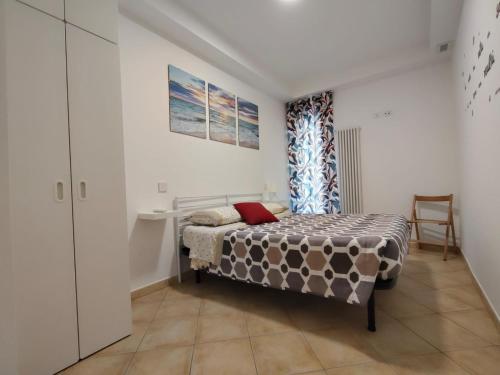 a bedroom with a bed and a chair in it at Oasi del Sole in Cupra Marittima