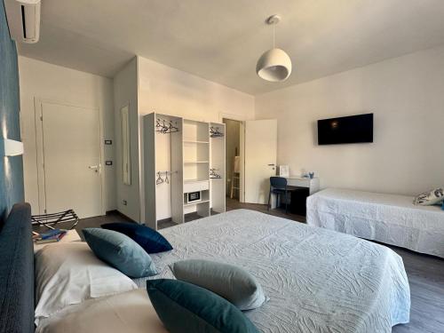 a bedroom with two beds with pillows at Perla di Mare in Martinsicuro