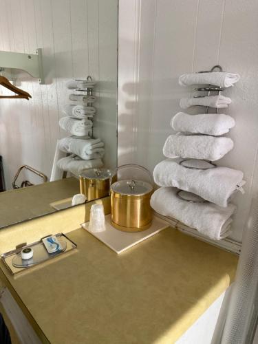 a pile of towels on a counter in a bathroom at Gateway Inn in Sullivan
