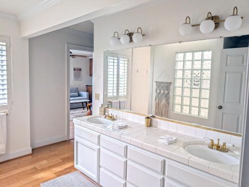 a bathroom with two sinks and a large mirror at The Vineyard Farmhouse Villa in Paso Robles