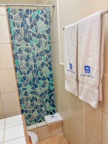 a bathroom with a shower with a mosaic shower curtain at St. Francis Suite in San Juan del Sur