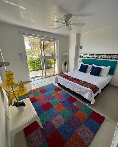 a bedroom with a bed and a colorful rug at Sunshine Boutique Hotel in San Andrés