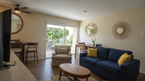 a living room with a blue couch and a table at Premier Resort Style Living Minutes from Santa Monica in Los Angeles