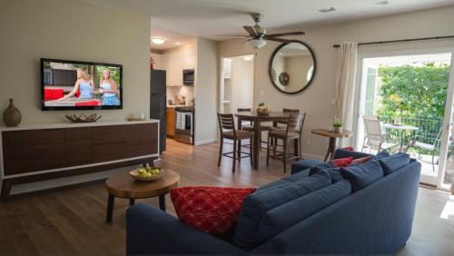 a living room with a blue couch and a dining room at Premier Resort Style Living Minutes from Santa Monica in Los Angeles