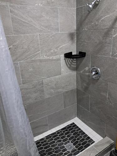 a bathroom with a shower with a glass door at Small's Cozy Rest 9 Efficiency in South Bimini