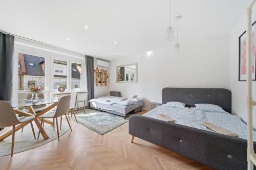 a bedroom with a bed and a dining room at Haban Haus in Bratislava