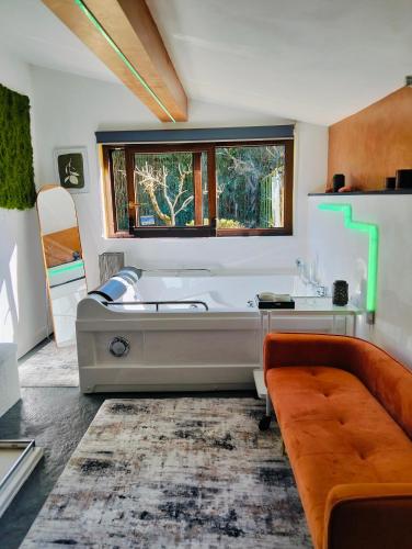 a living room with a large tub and a couch at Tudesia royal suite in Todi