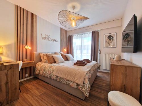a bedroom with a bed and a large window at Sweet Dove - Cocon de charme, balcon & parking privé in Chambéry